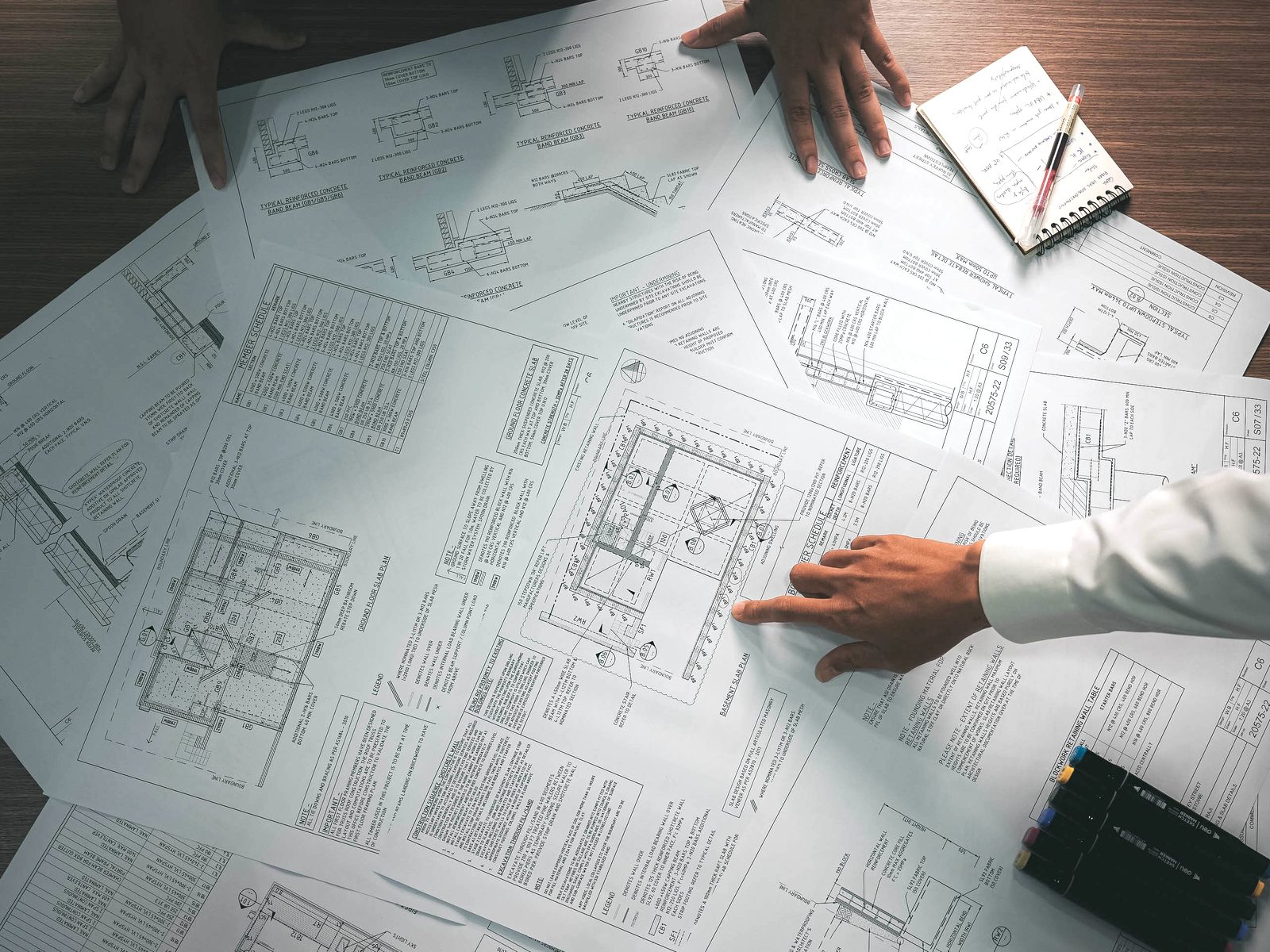 CommonWorks engineers reviewing structural drawings at the desk
